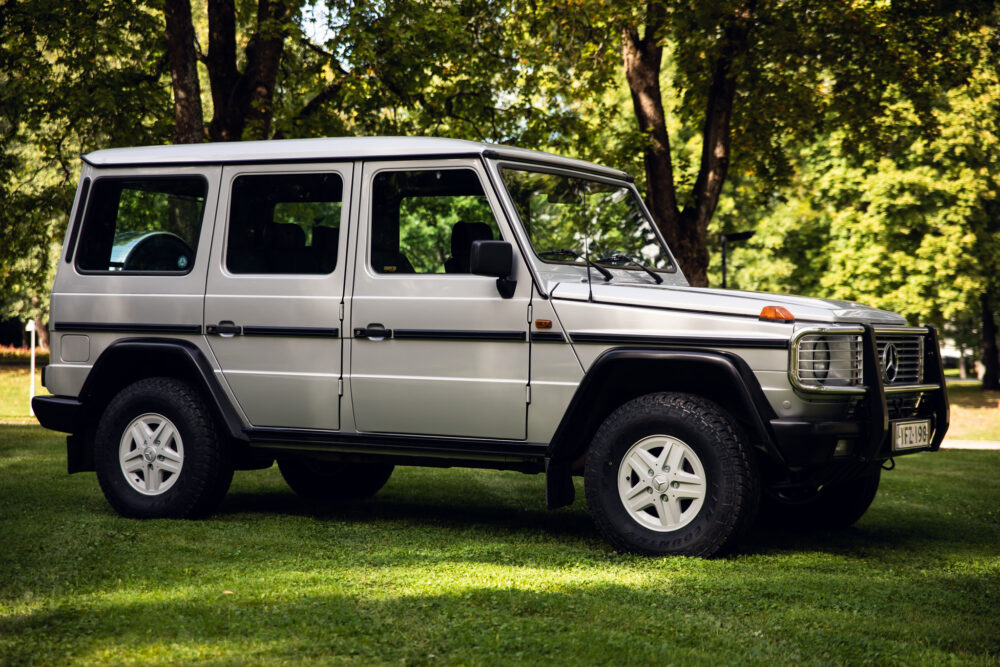 Silver SUV parked on grass in sunny park