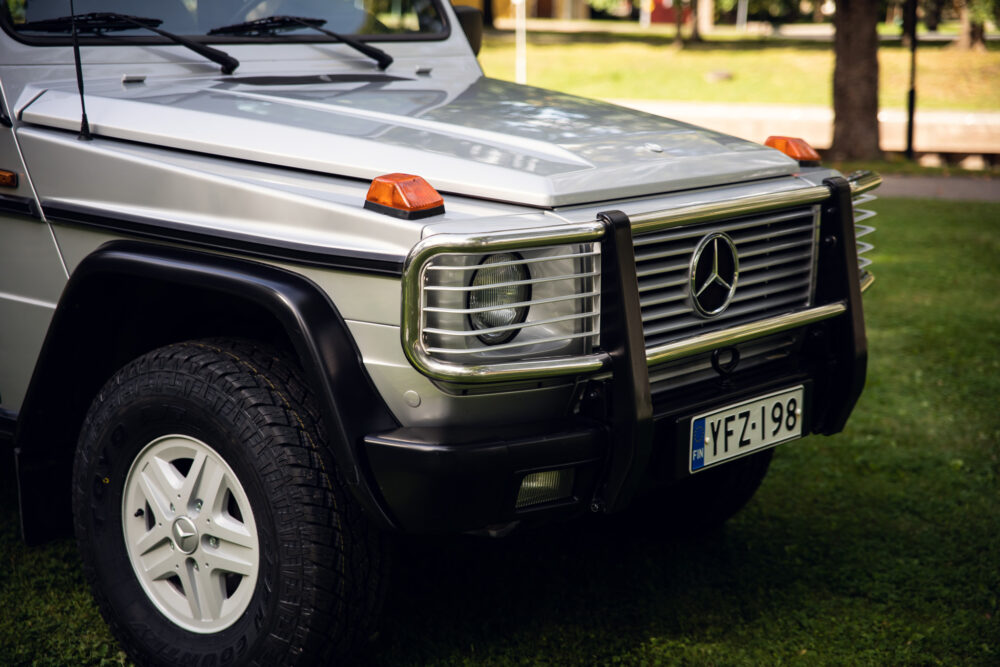 Silver Mercedes SUV parked on grass