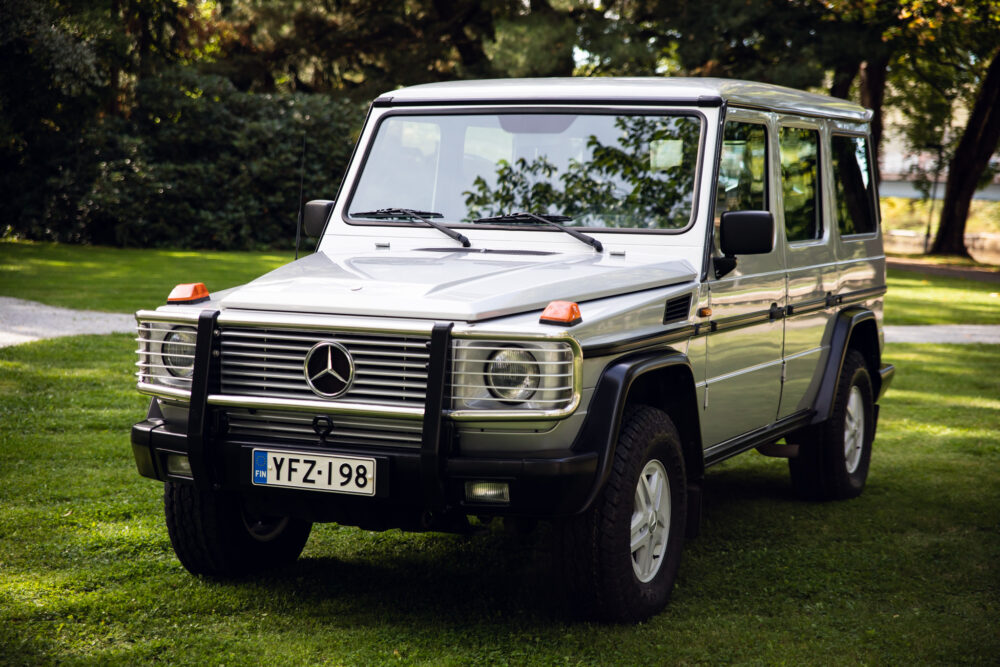 Silver Mercedes G-Class SUV parked on grass