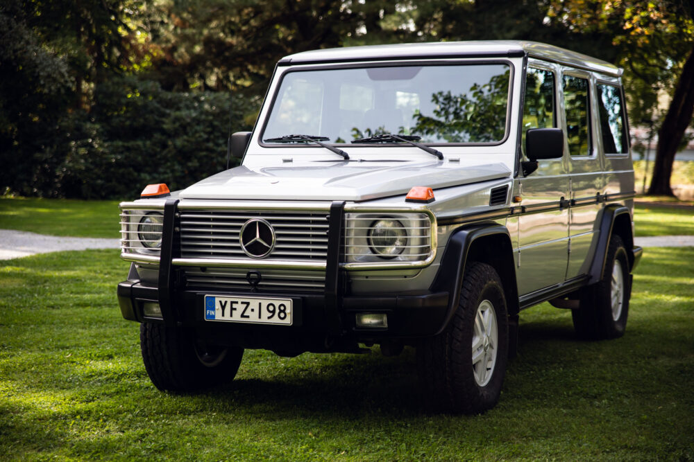 Silver Mercedes G-Class SUV parked on grass