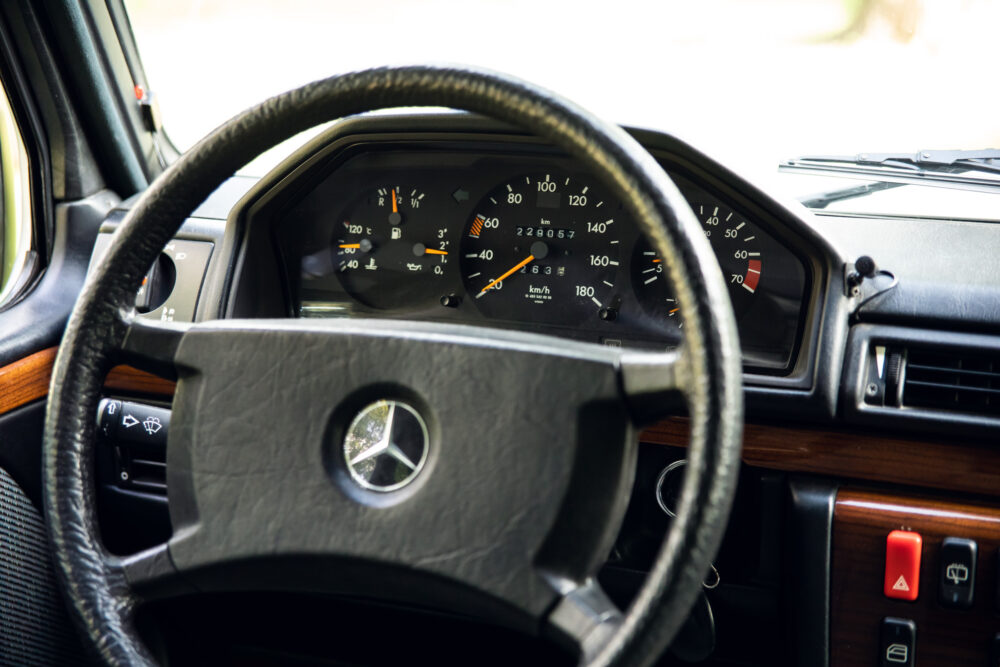 Vintage car dashboard with Mercedes-Benz logo on steering wheel