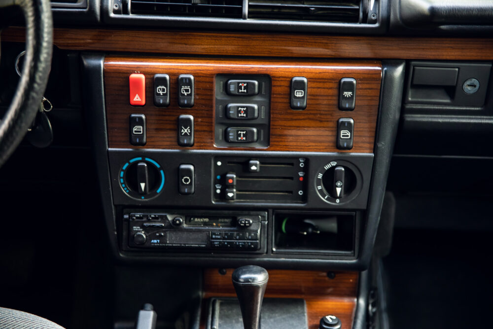 Vintage car dashboard with wooden panel and controls