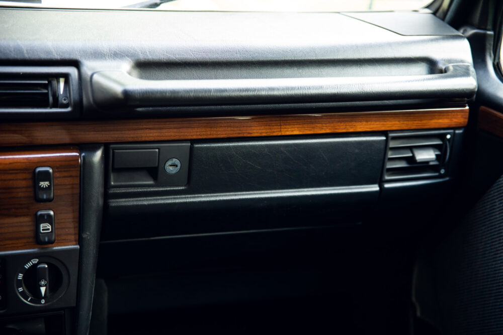 Close-up of classic car dashboard with wooden accents