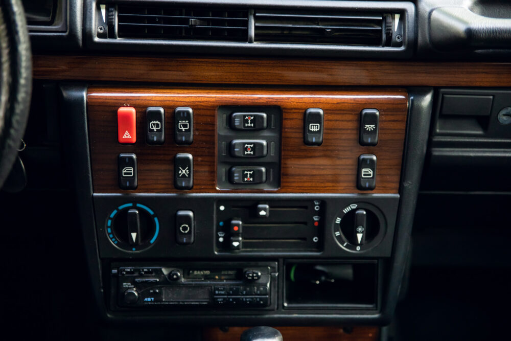 Vintage car dashboard with wooden panel and controls