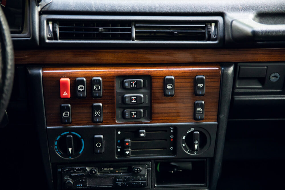 Vintage car dashboard with wooden panel and controls