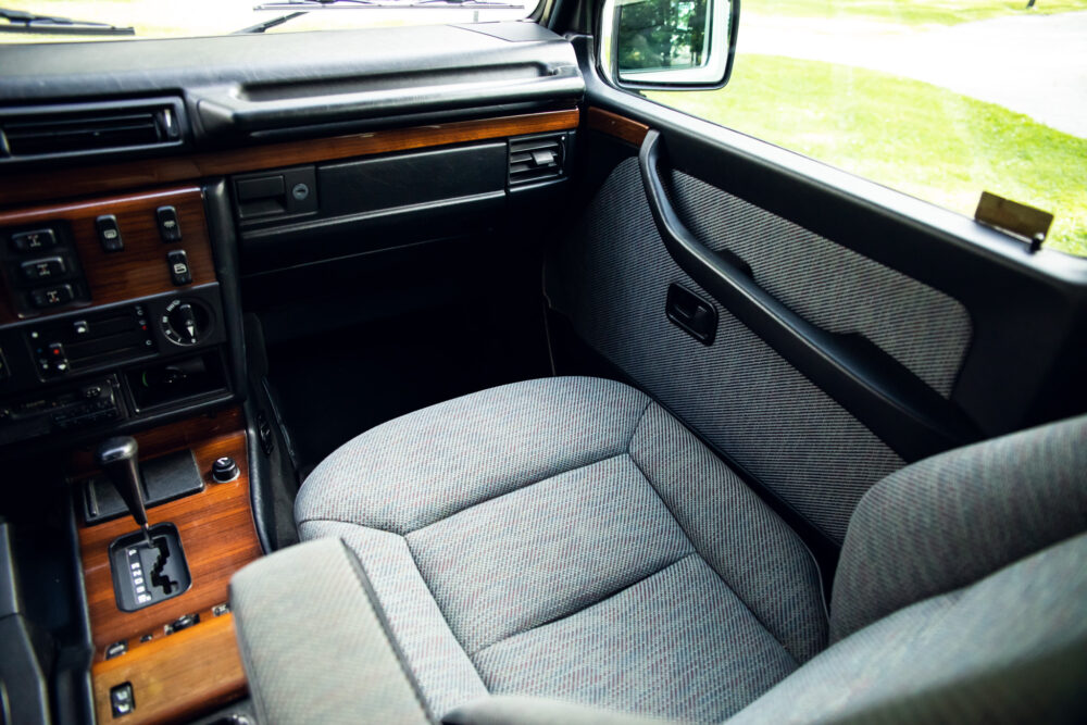 Classic car interior with patterned seats and dashboard