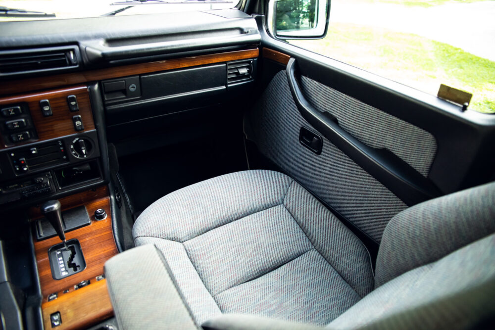 Vintage car interior with wooden dashboard and gray seats