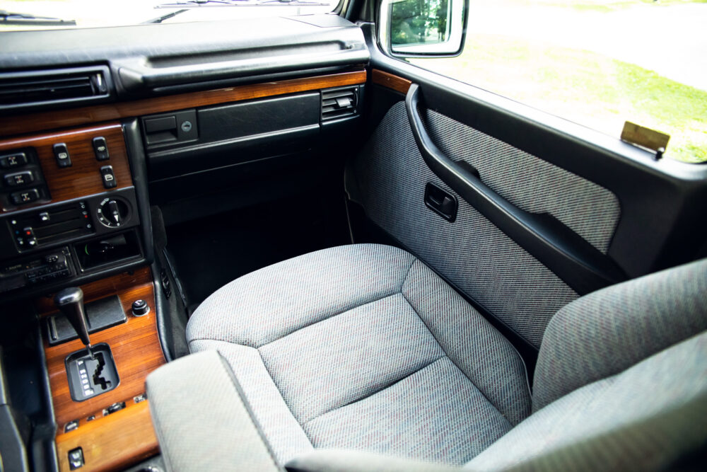 Vintage car interior with wooden dashboard and fabric seats