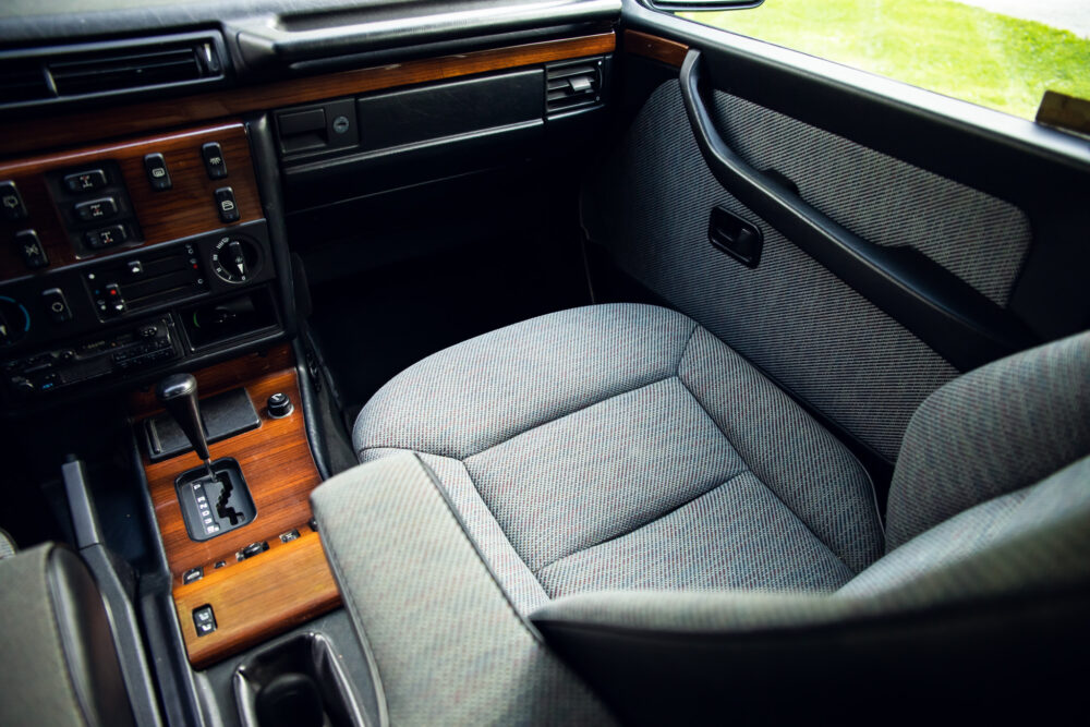 Vintage car interior with fabric seat and wooden dashboard