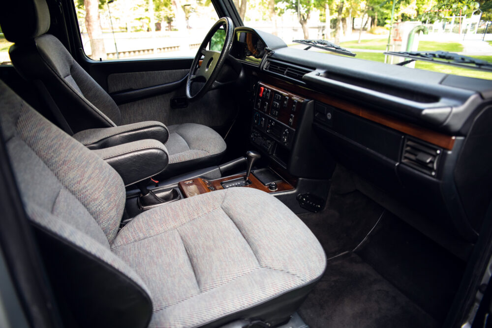 Vintage car interior with fabric seats and wooden dashboard