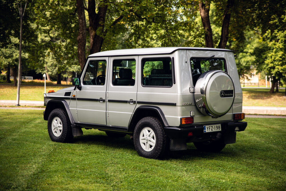 Silver Mercedes G-Class SUV parked on grass