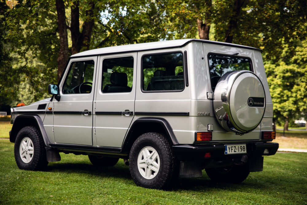 Silver Mercedes-Benz G-Class parked in lush park