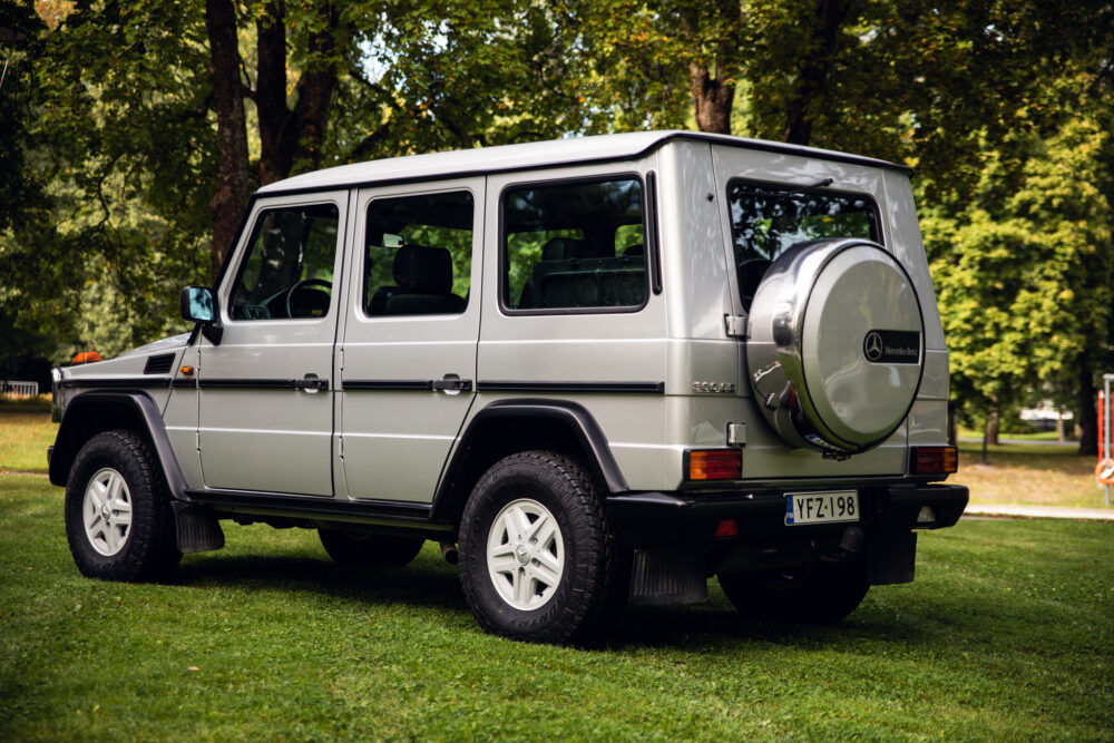 Silver Mercedes-Benz SUV parked on grass in park