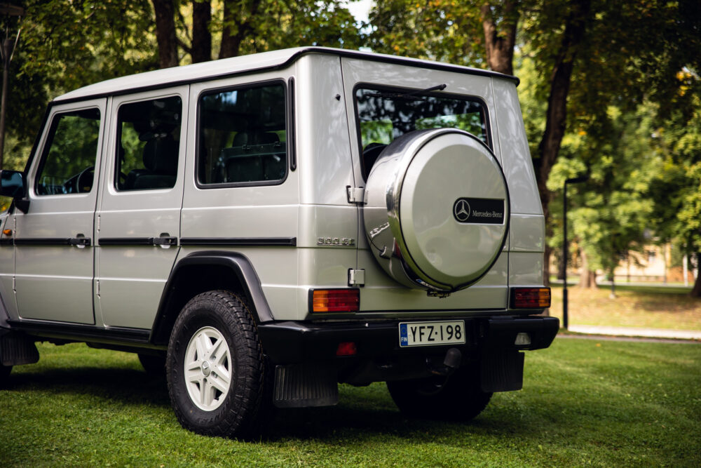 Silver Mercedes-Benz G-Class SUV parked in park