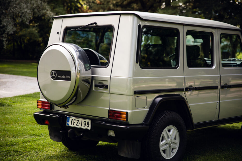 Gray Mercedes-Benz SUV with spare tire in park