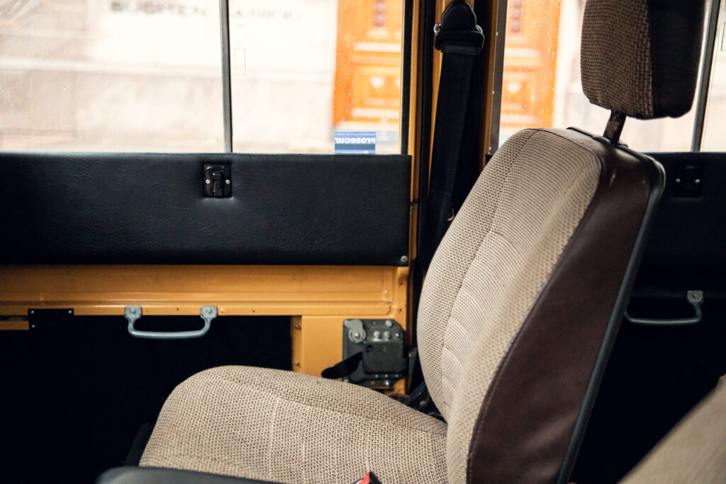 Interior view of an empty bus seat with window