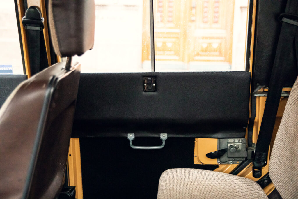 Empty bus seats with view of interior aisle
