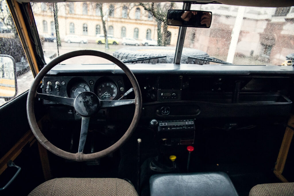 Vintage bus interior with steering wheel and raindrops