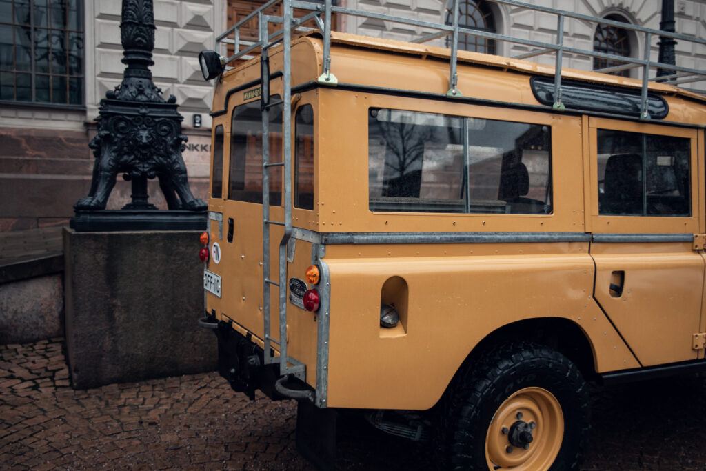 Vintage beige off-road vehicle parked near ornate lamp post