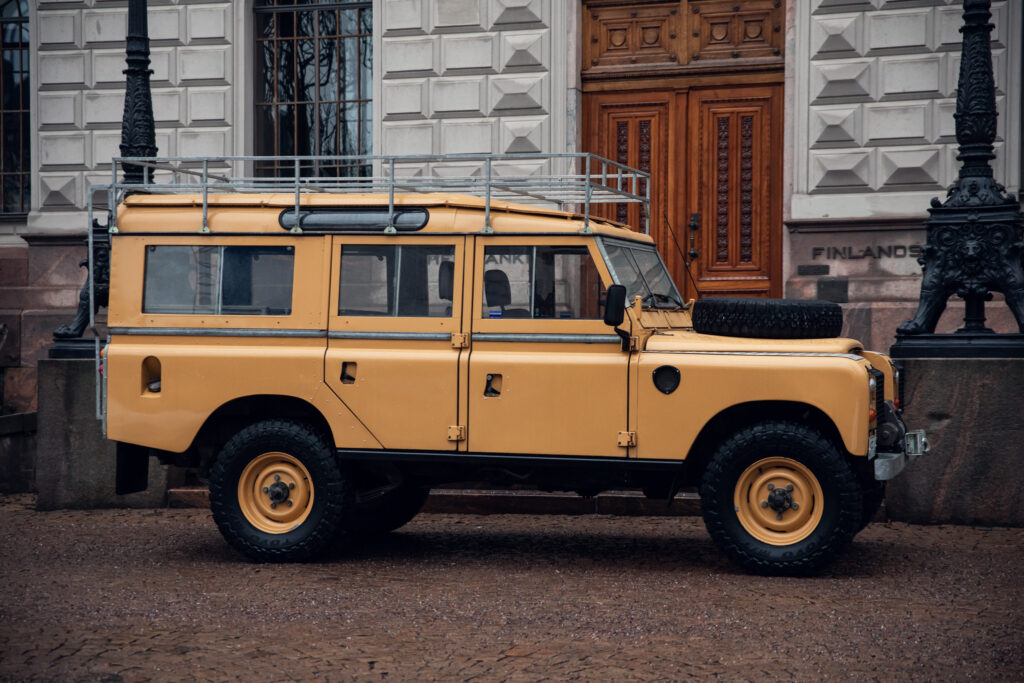Yellow Land Rover near historic building entrance