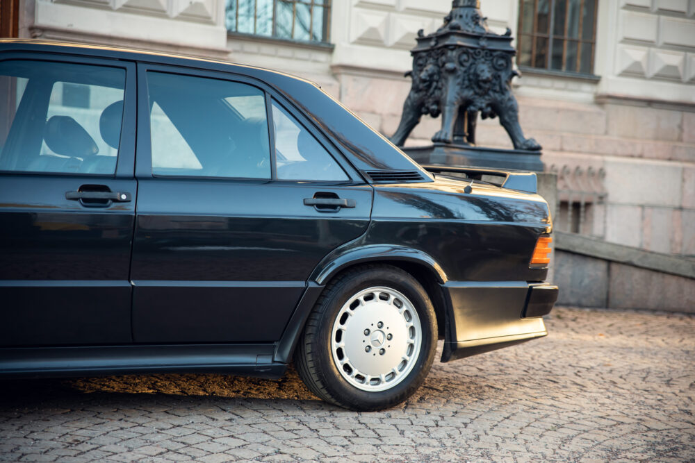 Vintage black car parked near historical building