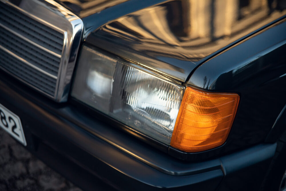 Close-up of vintage car headlight and grille