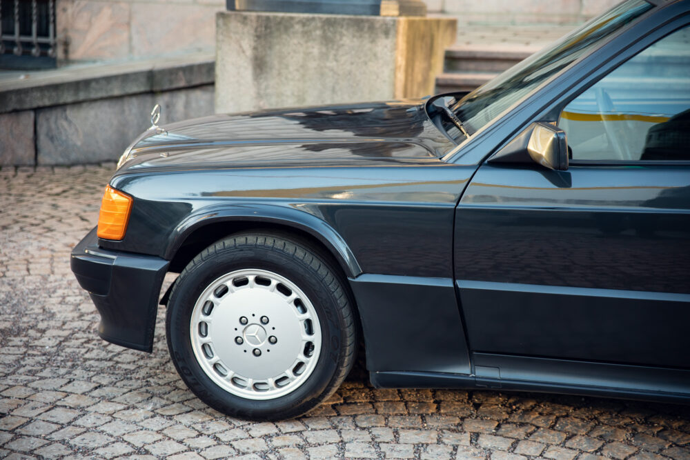 Vintage black Mercedes car parked on cobblestone street