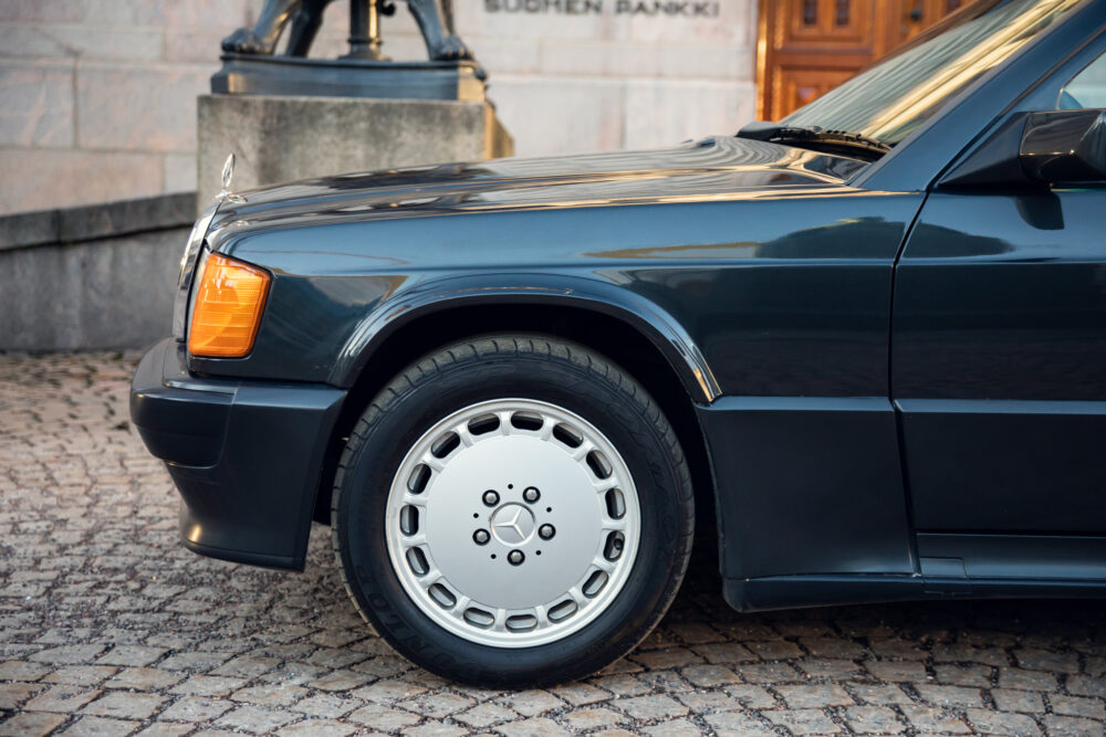 Vintage Mercedes car parked near stone building