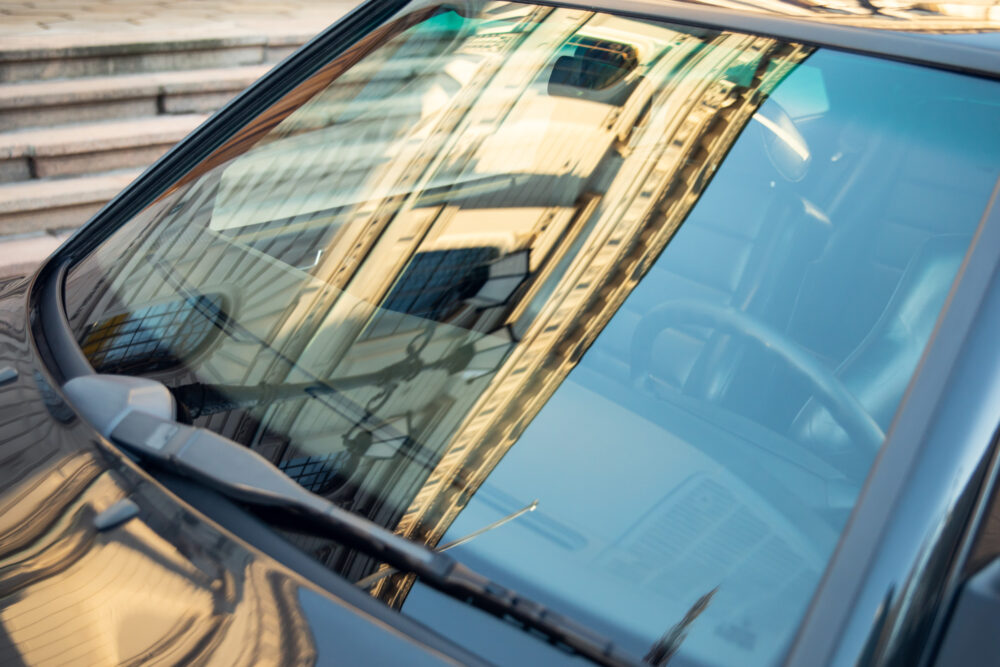 Reflection of urban buildings in car windshield