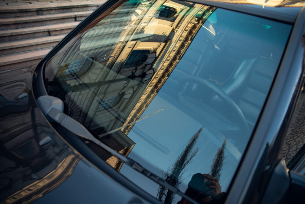 Reflection of historic building in car windshield