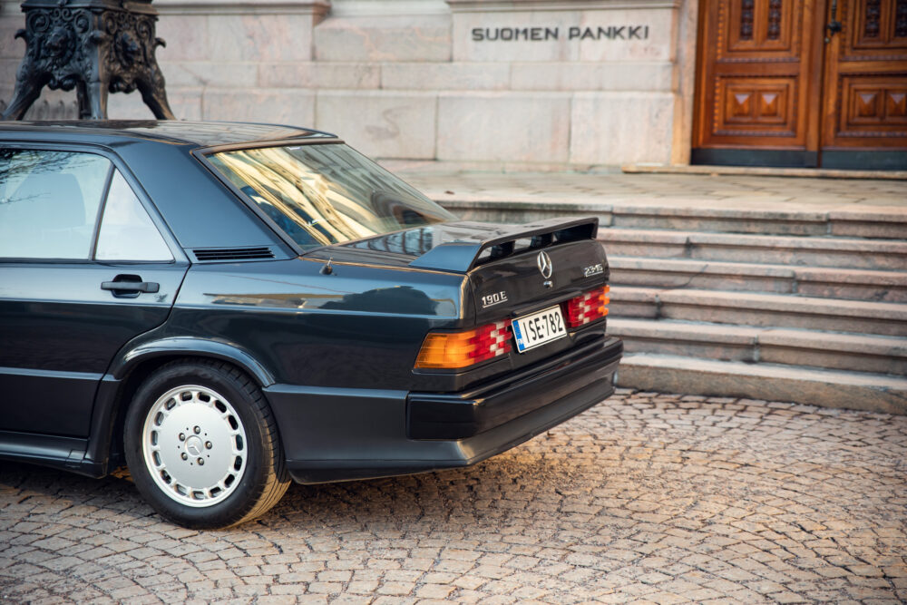 Vintage black Mercedes 190E parked outside Finnish bank