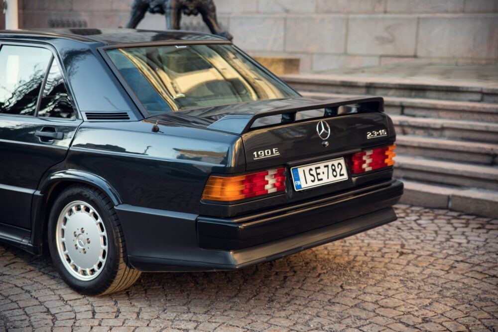 Vintage Mercedes 190E parked on cobblestone street