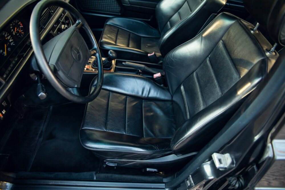 Vintage car interior with black leather seats and dashboard