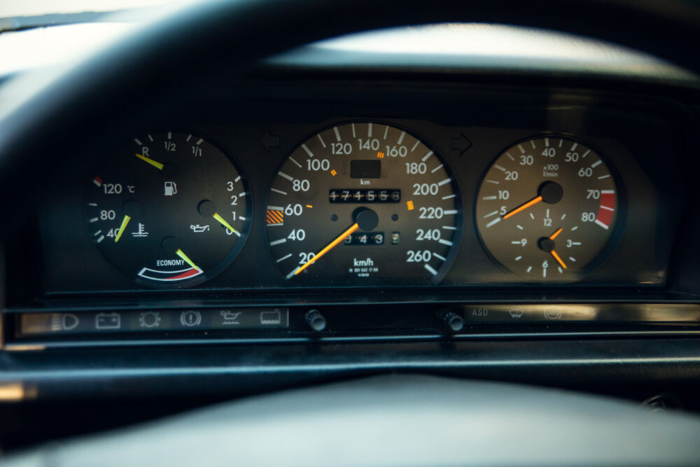 Close-up of car dashboard gauges indicating speed and fuel