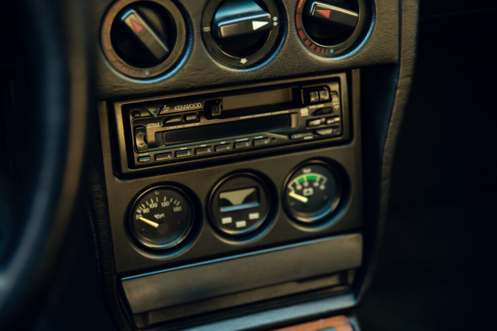 Vintage car dashboard with Kenwood stereo and gauges