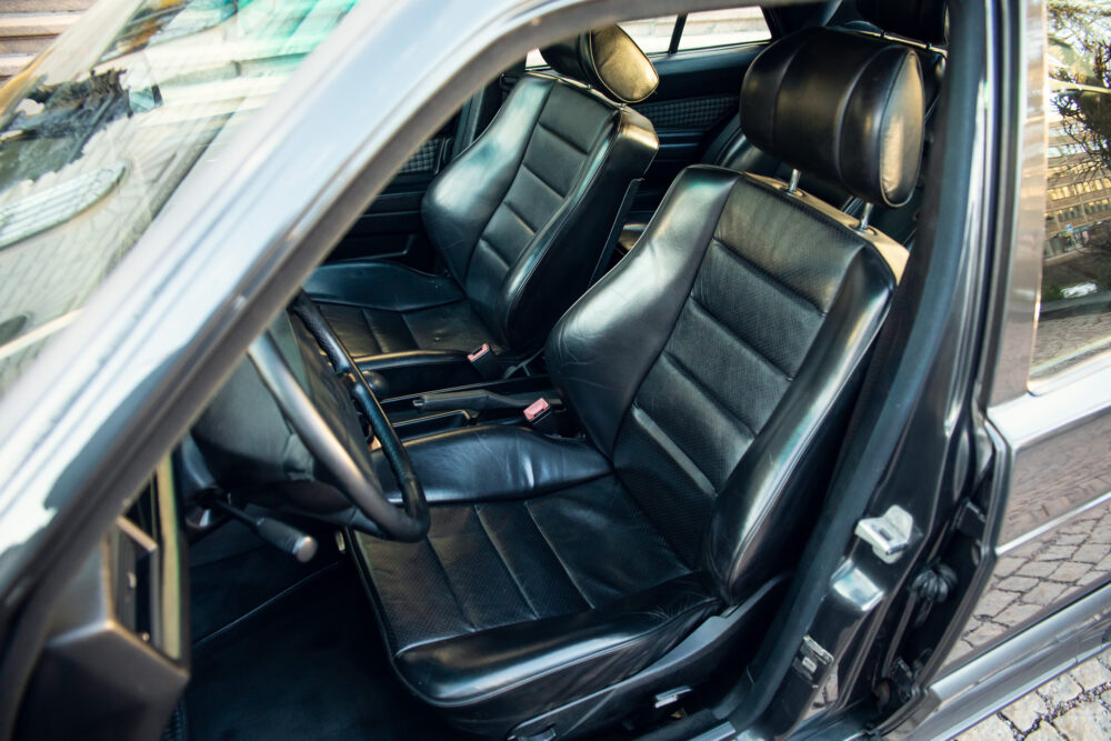 Black leather car interior, open door view