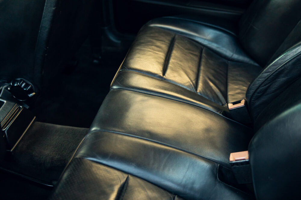 Vintage car's worn leather back seat interior