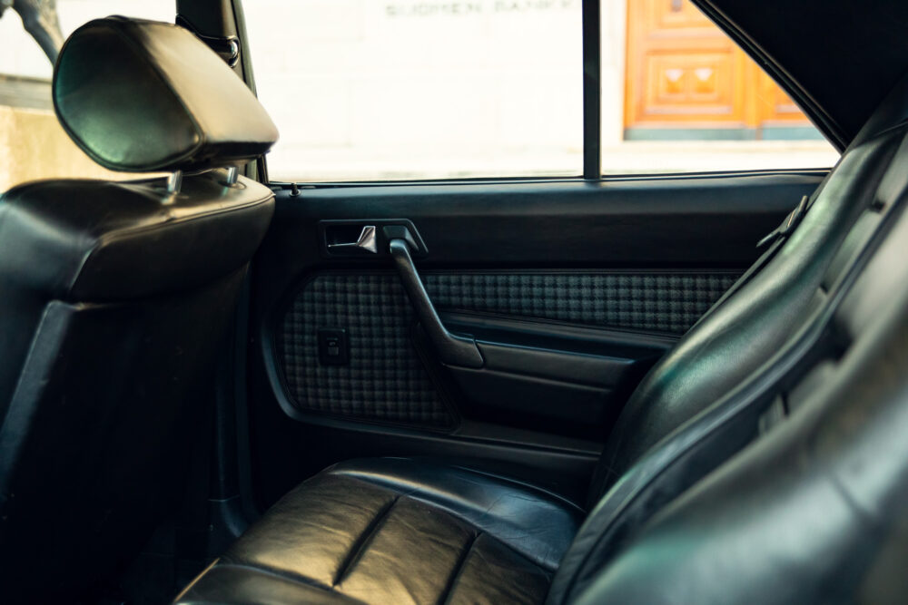 Vintage car interior with leather seats and window view