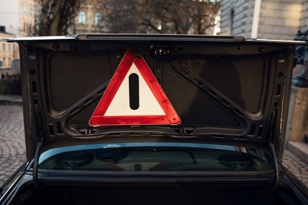 Red warning triangle in open car trunk