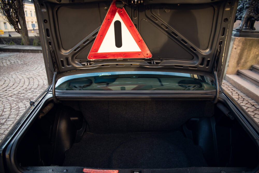 Car trunk open with safety triangle