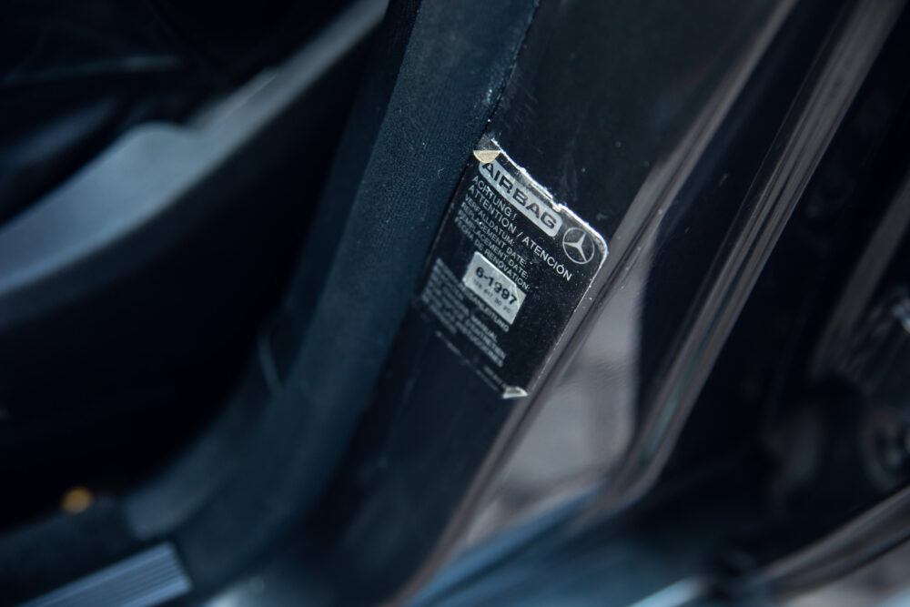 Close-up of car airbag information label on door