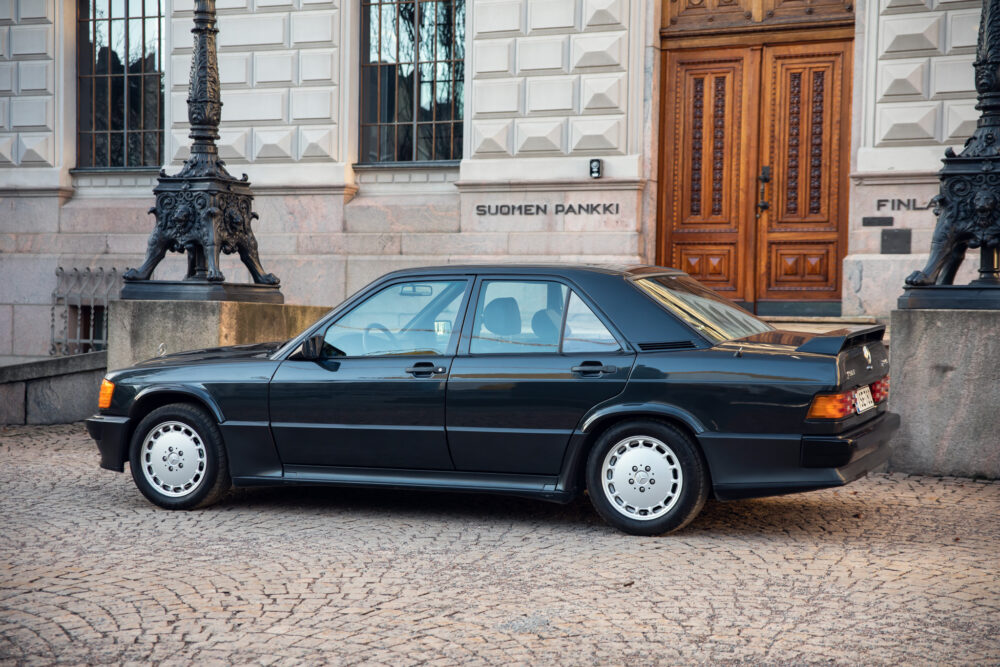 Vintage black sedan parked outside historic building