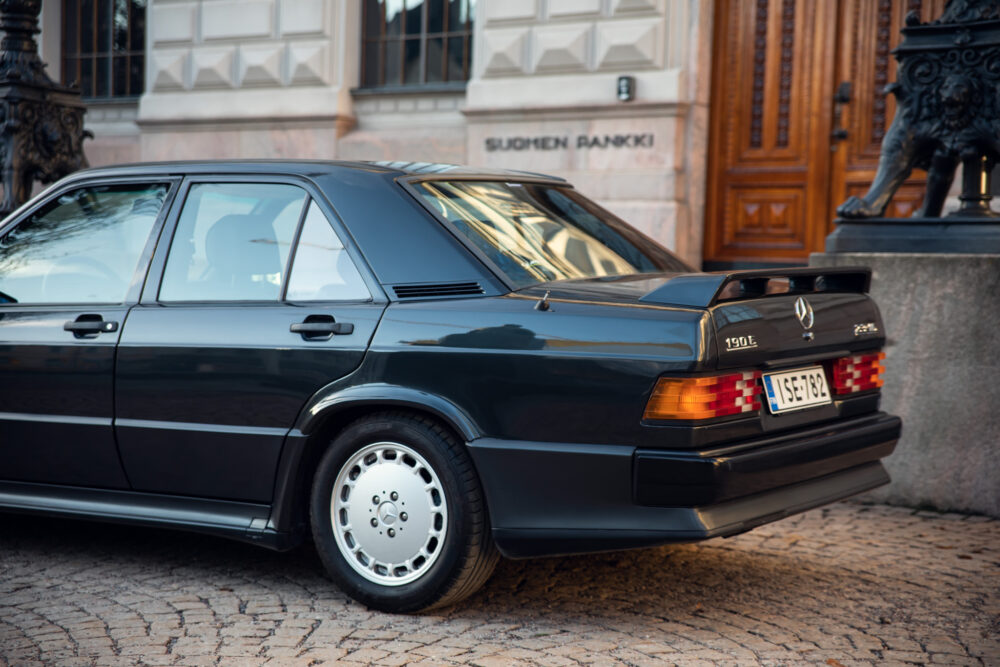 Vintage Mercedes-Benz 190E parked near ornate building