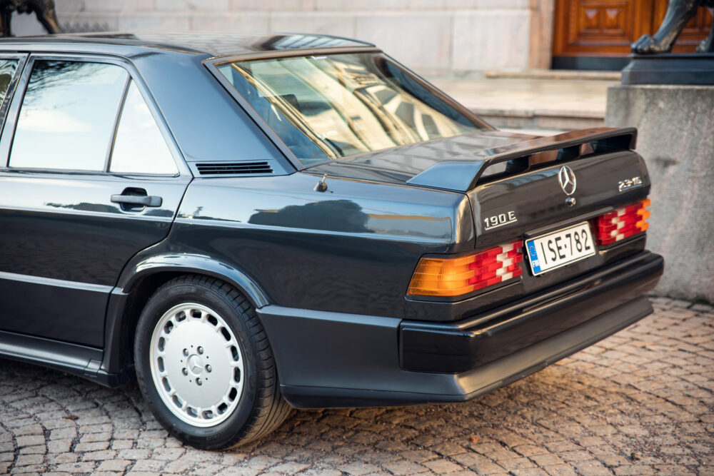 Vintage Mercedes-Benz 190E parked on cobblestone street