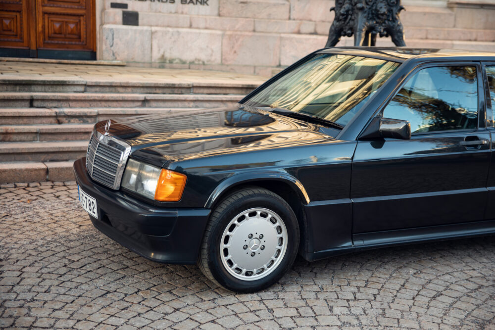 Vintage black Mercedes sedan parked by stone steps