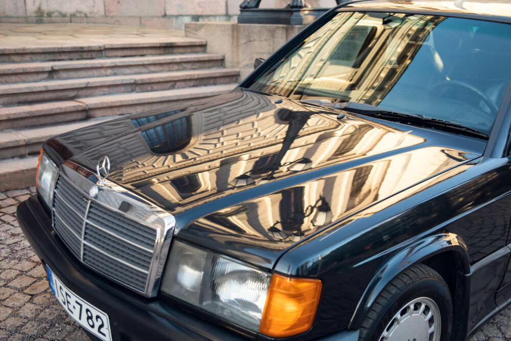 Vintage black Mercedes car parked near stone steps