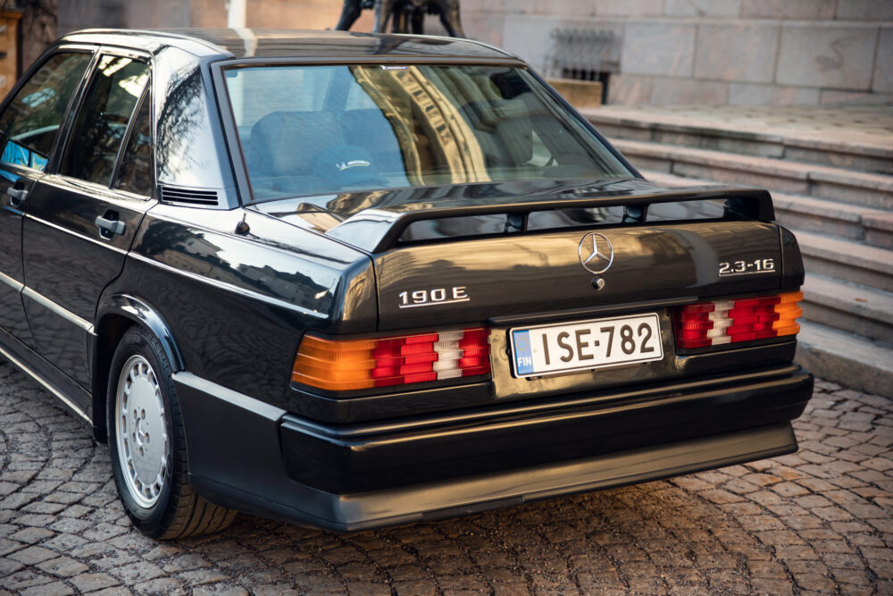 Vintage Mercedes 190E parked on cobblestone street