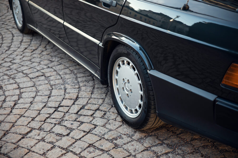 Classic black car on cobblestone street