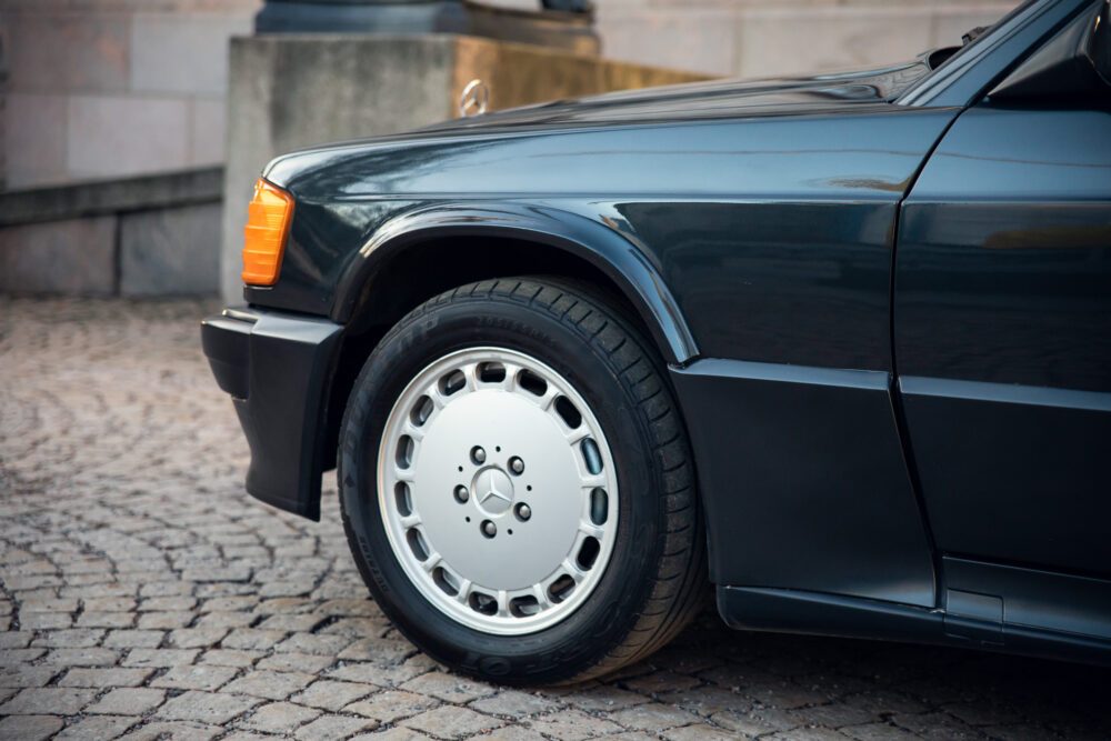 Close-up of vintage black car's front wheel and bumper