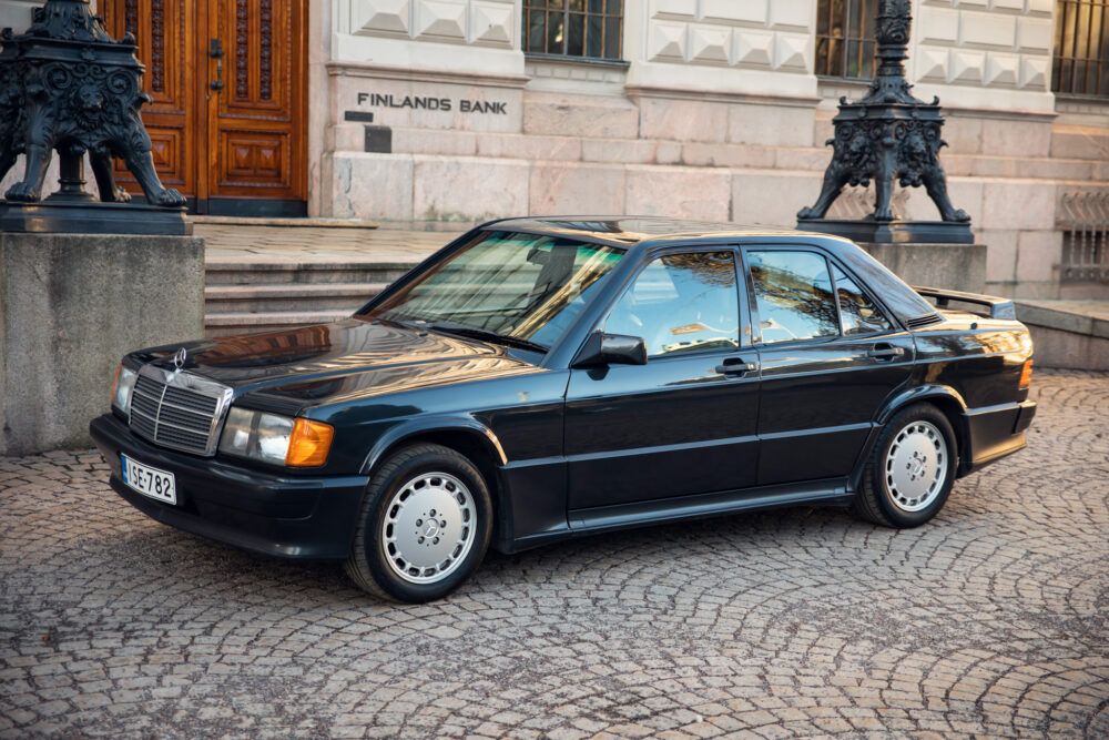 Vintage black Mercedes-Benz parked in front of bank